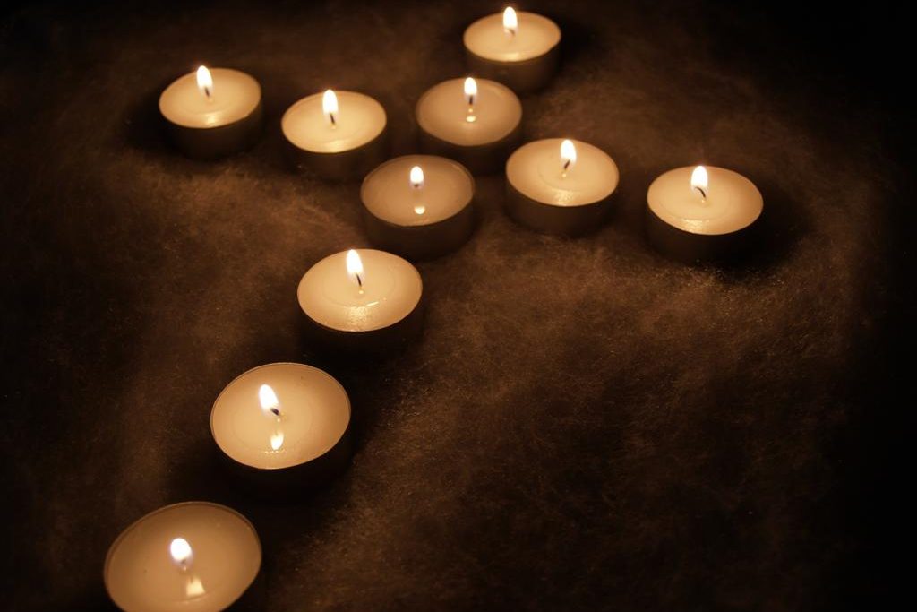 Tealight candles arranged in the shape of a cross